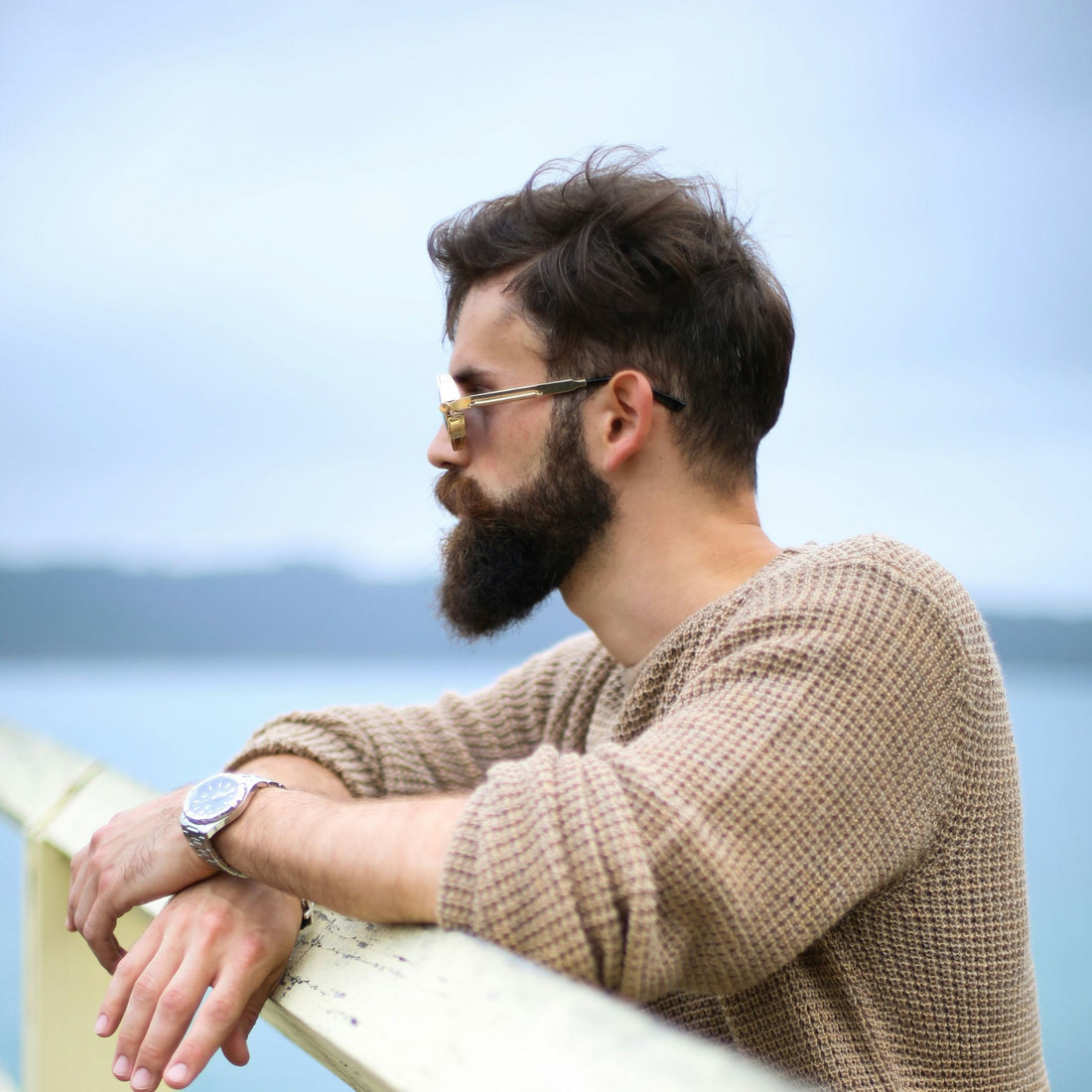 A bearded man by the ocean