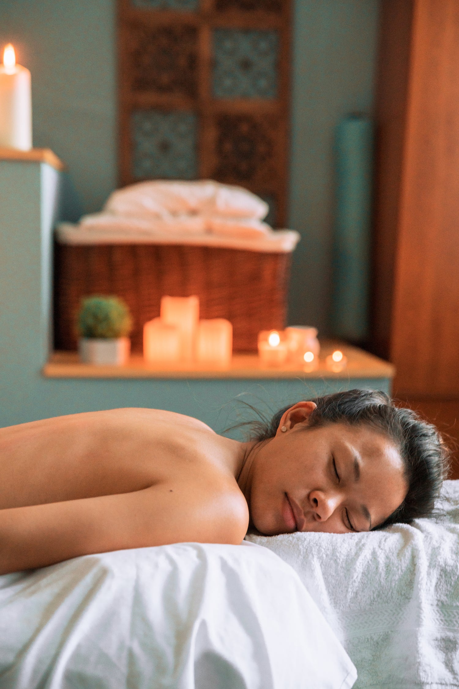 Woman lying down ready to enjoy a massage with an all natural cbd massage bar.