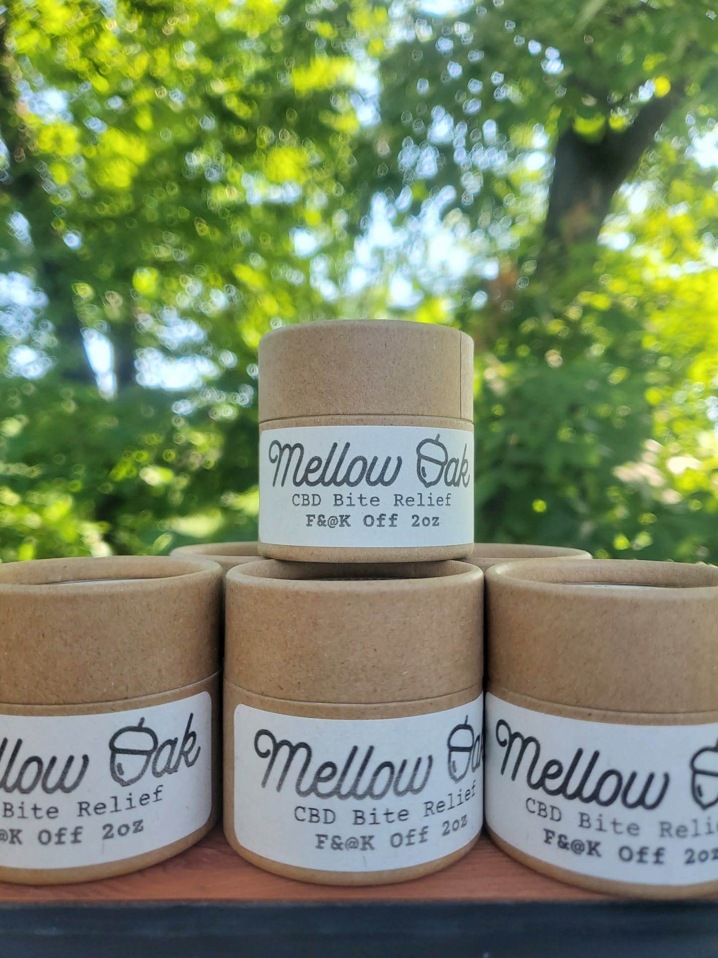 Several of our CBD bite relief salves packaged in zero waste, compostable paper tube jars.