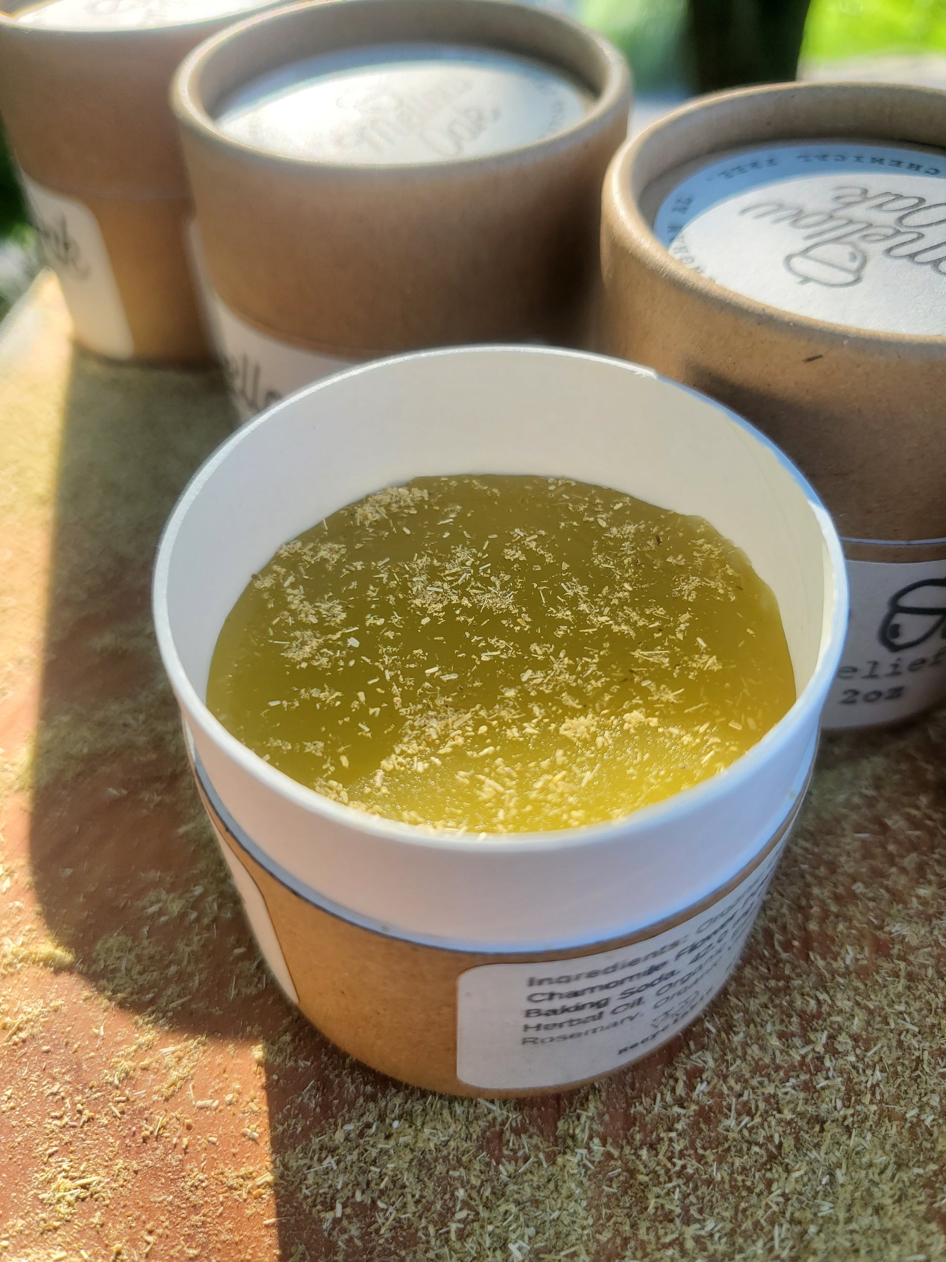 Close up view of the CBD bite relief salve. This salve contains CBD, beeswax, chamomile, and handpicked essential oils.